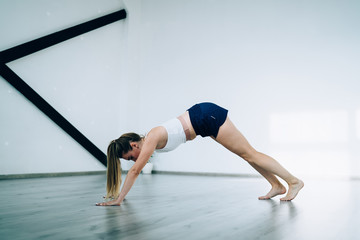 Fototapeta na wymiar Sportive woman preparing for yoga exercise