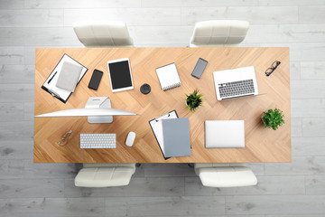 Modern office table with devices and chairs, top view