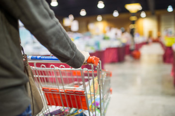 shopping cart on blur supermarket background.