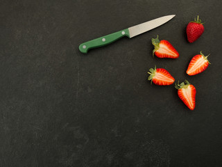 Fresh strawberries on slate background