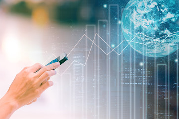Double exposure woman using smart phone for business online and purchase with trading graph background. Element of this images furnished by NASA
