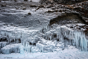 Fototapeta na wymiar Scenic icicles view on rocks of Olkhon Island, Baikal Lake by winter, Russia