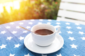 Hot coffee on table in garden