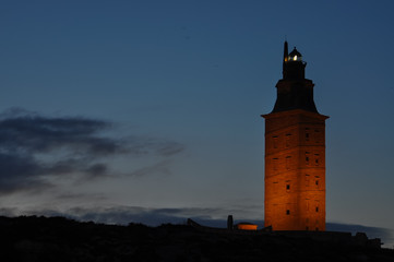 lighthouse at sunset iluminated by lights