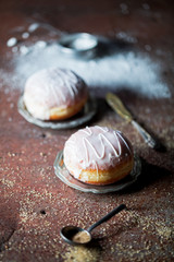 Donuts with icing on a rusty background.