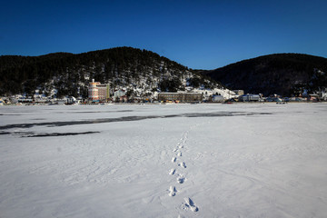 Frozen Baikal Lake view and Listvyanka village, Russia