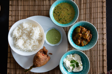Indian thali with mirchi bajji and daal . Mango picle as a side dishn with curd rice