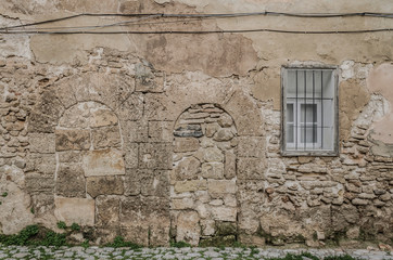 Mallorca, Spain, January 25th 2020: Rock wall with old arches and new windows