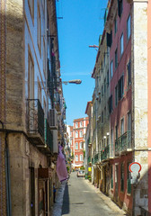 Fototapeta na wymiar Narrow street in the historic old town of Alfama, Lisbon, Portugal