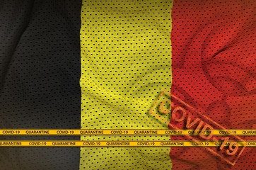 Belgium flag and orange Covid-19 stamp with border tape. Coronavirus or 2019-nCov virus concept