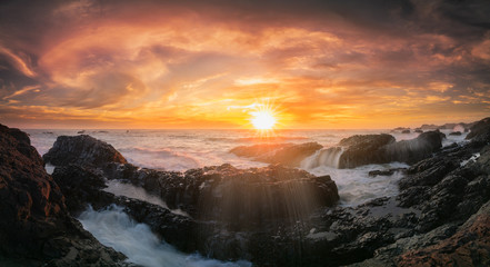 Fototapeta na wymiar Golden sunset and splashes at Beluga rock