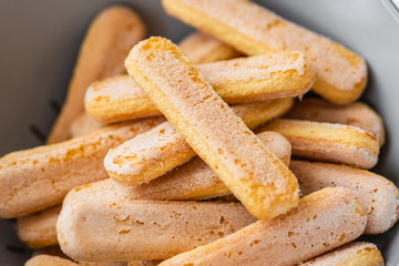 Close up of traditional italian coockie savoiardi. Biscuits in a grey bowl (pie dish)
