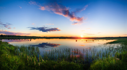 Fototapeta na wymiar Panorama of beautiful sunset over lake
