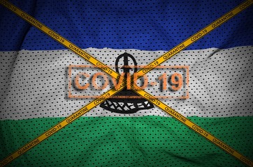 Lesotho flag and Covid-19 stamp with orange quarantine border tape cross. Coronavirus or 2019-nCov...