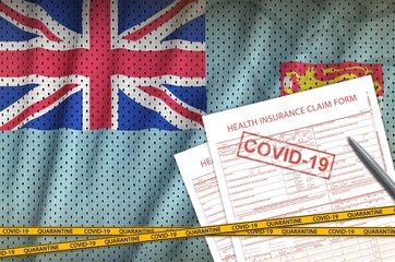 Fiji flag and Health insurance claim form with covid-19 stamp. Coronavirus or 2019-nCov virus...