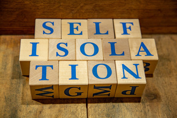 Wooden cubes with lettering Self-isolation in blue letters