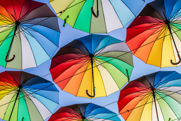 Colorful umbrellas Blue, green, red, rainbow umbrellas background Street with umbrellasin the sky Street decoration.