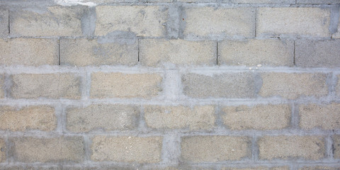 Grey brick cinderblocks wall closeup texture concrete block background