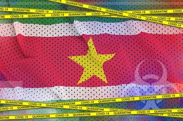 Suriname flag and Covid-19 quarantine yellow tape. Coronavirus or 2019-nCov virus concept