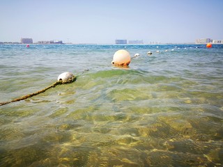 Buoys float on the surface of the water from the Persian Gulf