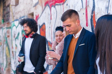 Group of friends (colleagues) hanging out in an urban area.