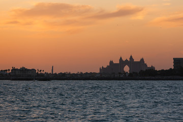 silhouette of the building on the sea shore sunset