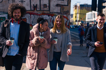 Group of friends (colleagues) hanging out in an urban area.