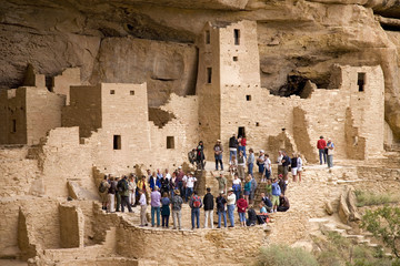 Tourists viewing kiva at Cliff Palace cliff dwelling Indian ruin, the largest in North America, Mesa Verde National Park, Southwestern Colorado