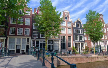 Fototapeta na wymiar Typical old houses of Amsterdam under blue sky.
