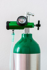 Detail of an oxygen pressure gauge and cylinder with white background