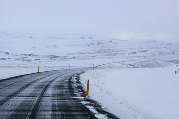 Fototapeta na wymiar Snow-covered roads of northern Iceland, long way to go