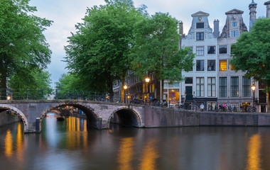 Naklejka premium Beautiful view of Amsterdam canals with bridge and typical dutch houses. Holland