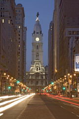 William Penn statue on the top of City Hall at dusk and streaked car lights from Broad Street, Philadelphia, Pennsylvania, the City of Brotherly Love
