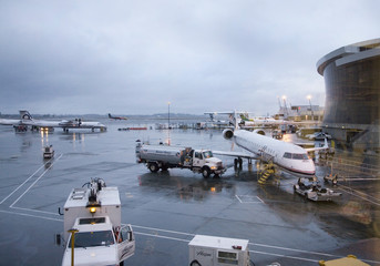 Salt Lake City International airport with jets and stormy skies in the background