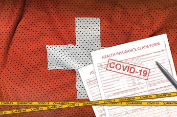 Switzerland flag and Health insurance claim form with covid-19 stamp. Coronavirus or 2019-nCov...