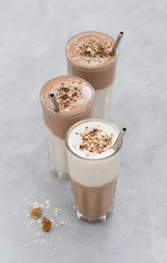 Smoothies from dried fruits, walnuts, chocolate with smoothies oatmeal in a glass on a light background