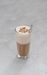 Vegan combination drink smoothies made from dried fruits, nuts, chocolate and oatmeal smoothies in a glass on a light background