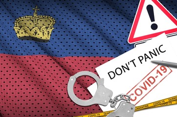 Liechtenstein flag and police handcuffs with inscription Don't panic on white paper. Coronavirus or...