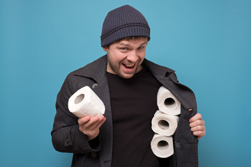 speculator man holding several roll of toilet paper. Do you want to buy it