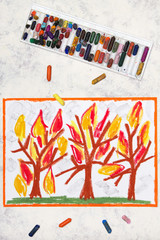 Photo of colorful drawing: burning trees in fire flames. Wildfire forest.