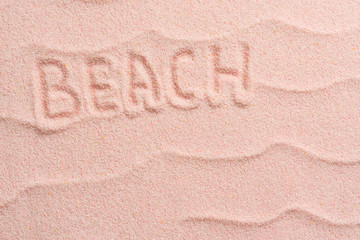 Fototapeta na wymiar BEACH lettering on sand with wave. Minimal exotic vacation and travel concept, Flat lay top view copy space