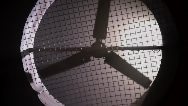 Close-up rotating fan blades in industrial room for air filtration in dark background. Slow motion