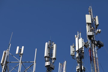 Mobile towers on blue sky background. Many communication equipment.