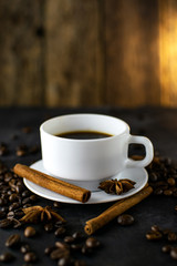 Coffee with beans on dark background