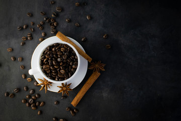 Coffee with beans on dark background