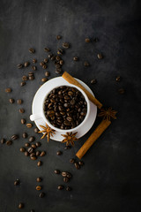 Coffee with beans on dark background