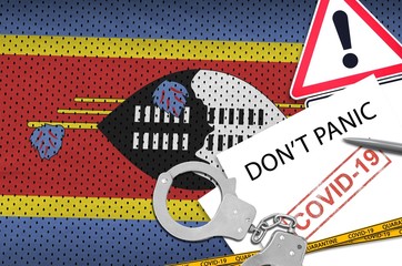 Swaziland flag and police handcuffs with inscription Don't panic on white paper. Coronavirus or...