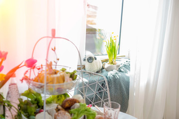 Focus on background: decorative sheep ornament on a window during Easter celebration. Selective focus. Easter-themed home decor.