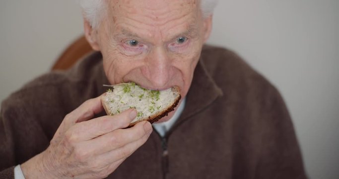 Retirement - Senior Man Eating Sandwitch.