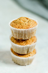 Healthy vegan snack carrot muffins cupcakes stacked with brown sugar on the plate  chopped nuts